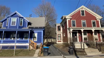 Blue and red colonial-style multifamily homes in Vermont.