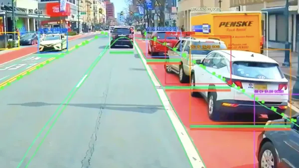 View from bus-mounted AI-assisted camera identifying vehicles parked in red designated bus lane.