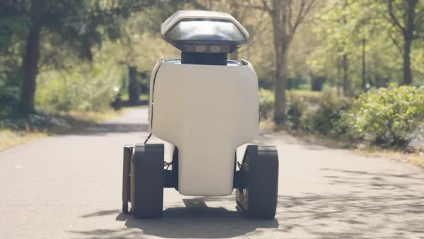White robot drivign down sidewalk in Irvine, California.