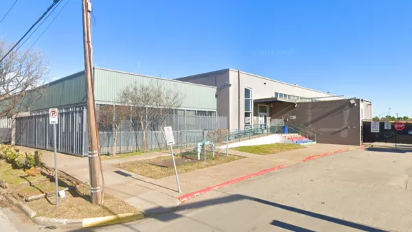 Street view of one-story commercial building with few windows  in Houston, Texas.