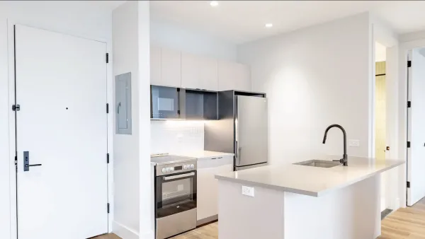 Open plan kitchen interior of apartment in New York City without furniture or decor.