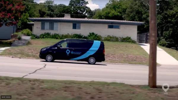 A blue microtransit van drives through Texas