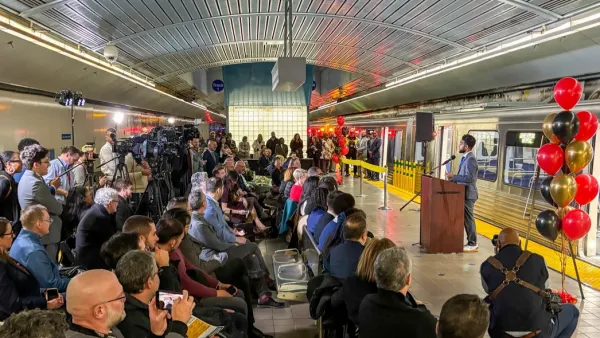 Crowd assembled at event in Baltimore subway station for debut of new subway cars.