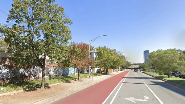 Red painted bus lane on street in Baltimore, Maryland.