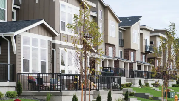 Small two-story multifamily homes next to each other with small green lawns in front in Spokane, Washington.