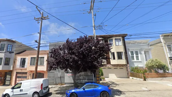 Google street view of two-story residential building on San Francisco street covered in construction netting between other homes.