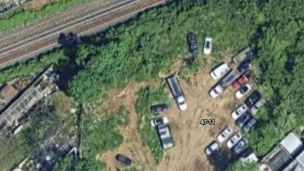 The paved-over cemetery, with trucks on top of the lot.