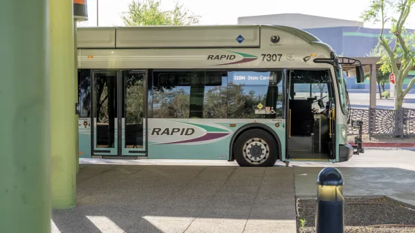 A white RAPID bus. The lower half is light blue, and says RAPID in purple text. The bus is half visible, appearing from the left side of the image.