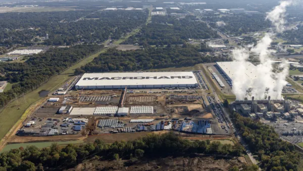 An aerial view of the xAI data center in Mississippi. Smoke is billowing out of turbines. 