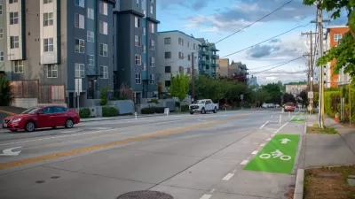 Green painted bike lane on street next to modern mid-rise apartment buildings in Seattle, Washington.
