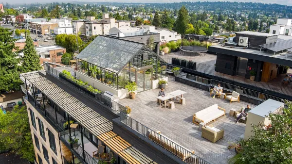 Aerial view of Shared Roof apartment building in Seattle with glass greenhouse on roof.