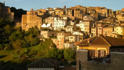 The city of Siena in Italy, located on a hillside and bathed in Tuscan sunlight.