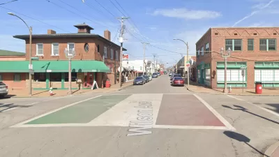 An intersection is adorned with paint depicting the Italian flag in St. Louis.