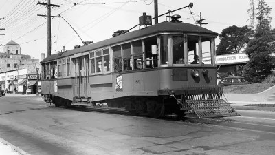 Black and white photo of a streetcar from the 1900s.