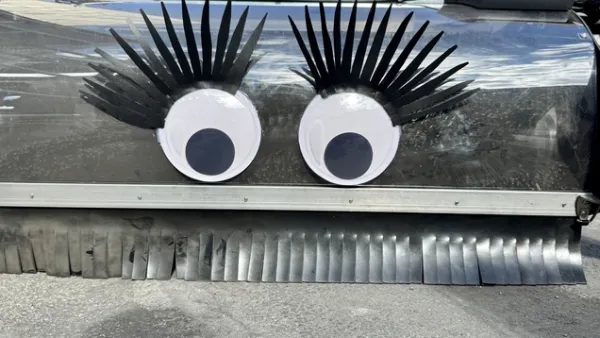Close-up on googly eyes on bike lane sweeper.