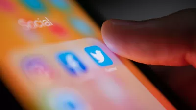 A person’s thumb hovers over the Twitter app on a smart phone.