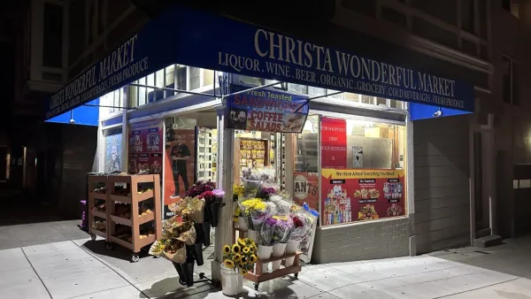 A picture of a corner store at night.