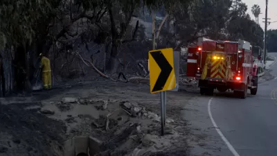 Fire engine parked by burned area during Woolsey Fire