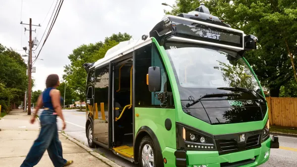 A person boarding a green ATL bus.