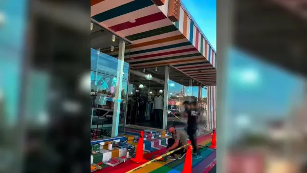 Screenshot from TikTok video of people painting rainbow sidealk in front of clothing store in Houston, Texas.
