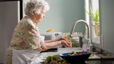Senior Woman Washing Vegetables