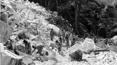 Incarcerated people work in a rock quarry, possibly Keith Quarry near Palmetto, Georgia, around 1948.