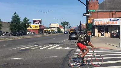 Person biking at intersection between Atlantic Avenue and Franklin Avenue in Brooklyn, New York City