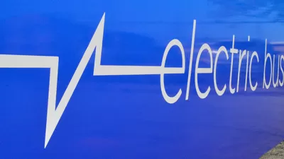 Close-up of white "electric bus" logo on side of blue Chicago public transit bus