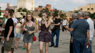 Young and all people stroll at a community event in New York City.
