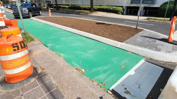 Green painted and curb protected bike lane under construction in Atlanta, Georgia.