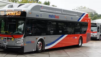 Silver and red WMATA public bus at station in Washington, D.C.