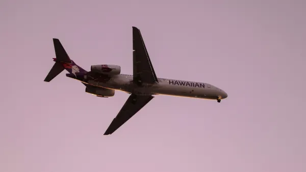Hawaiian Airlines airplane flying in a pink sky