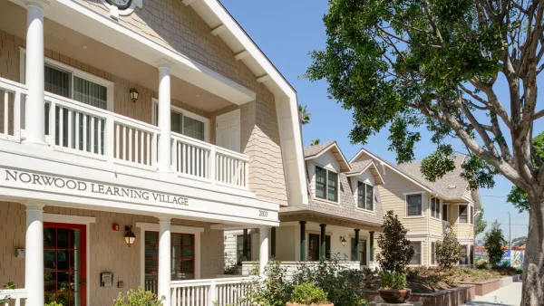 Row of light-colored craftsman homes, part of Norwood Learning Village teacher housing in Los Angeles.