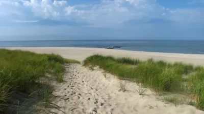 An image of a path through sand dunes to ocean in New Jersey