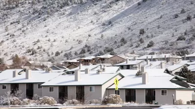 One-story houses dusted with snow in Durango, Colorado with snowy mountainside in background