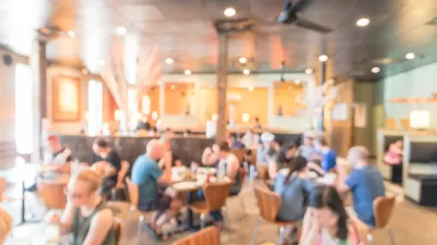 Blurred photo of crowded, brightly lit restaurant