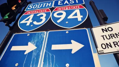 Closeup of blue I-94 and I-43 signs with arrows