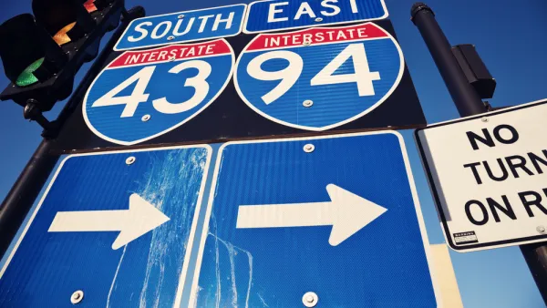 Closeup of blue I-94 and I-43 signs with arrows