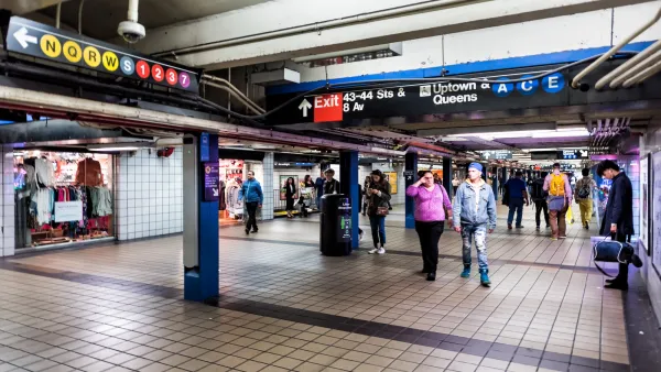 New York City subway station with people walking through.