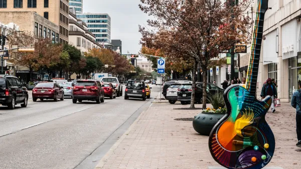 Guitar-shaped sculpture on sidewlak on Congress Avenue in Austin, Texas.