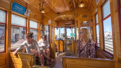 Passengers inside wood-paneled TECO streetcar in Tampa, Florida
