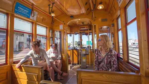 Passengers inside wood-paneled TECO streetcar in Tampa, Florida