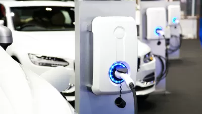 Row of white electric cars at charging station