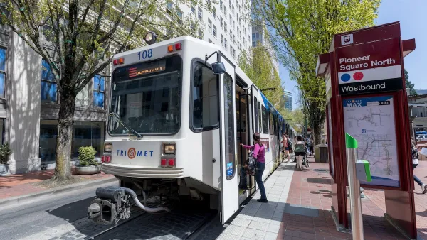 Passenger boarding white streetcar in Portland, Oregon.