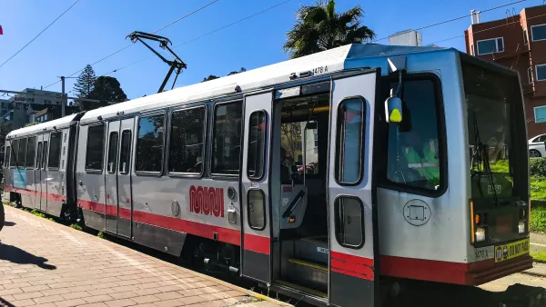 Red and white San Francisco Muni tram.