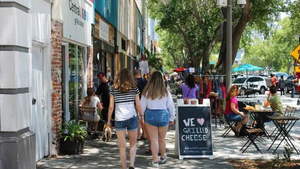 People walking down busy commercial street in St. Petersburg, Florida.