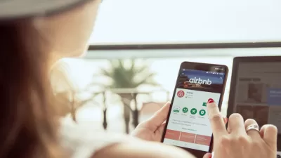 Woman searchinig Airbnb app on phone