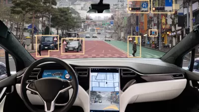 View from inside driver's seat of car with autonomous technology, with yellow rectangles highlighting obstacles in road