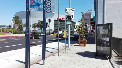 Bus stop in downtown Los Angeles with billboard and no bench or shelter