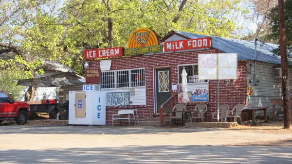 Small brick food store with vintage signs and new handwritten signs for Mi Pueblo food store.
